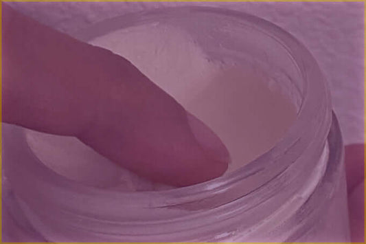 Dipping finger in cream jar
