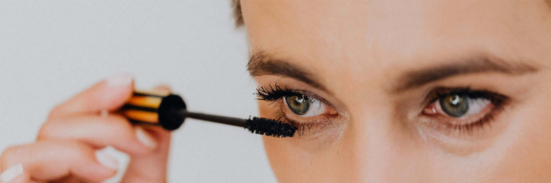 A lady applying mascara